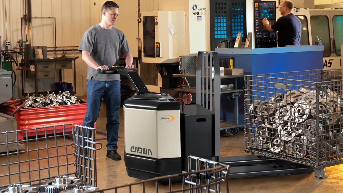 Operator moving stock with a walkie stacker in a warehouse